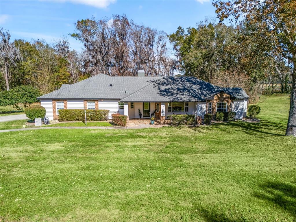 a front view of a house with a garden
