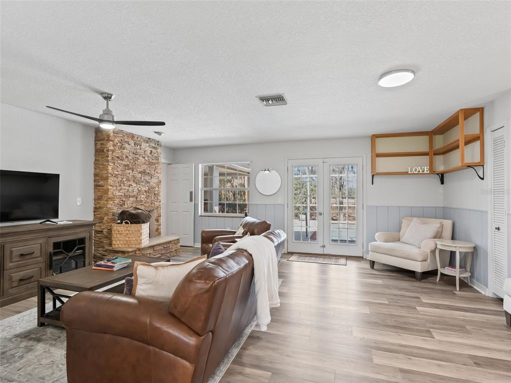8916 Southwest 8th Street Ocala, FL 34481 - Photo 11 of 40 a living room with fireplace furniture and a flat screen tv