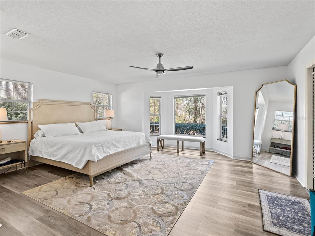 8916 Southwest 8th Street Ocala, FL 34481 - Photo 15 of 40 a bed room with a bed and a chair