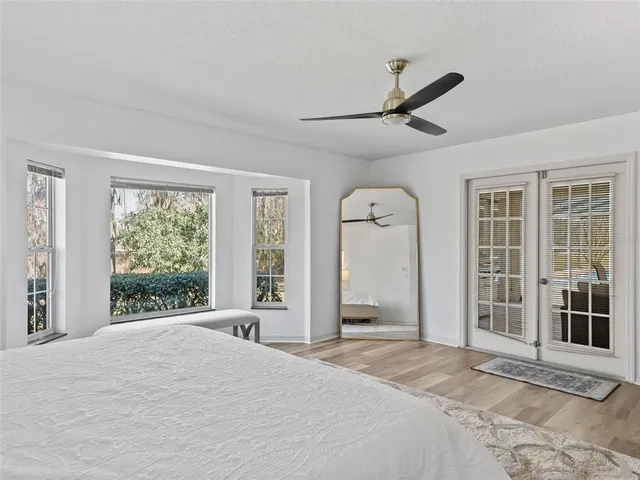 a bedroom with a bed and a large window