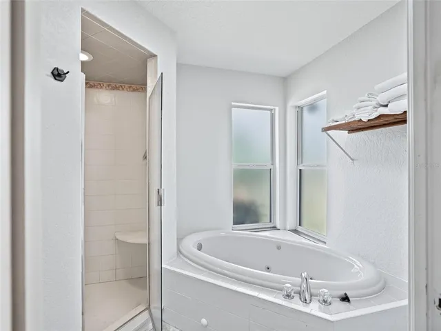 a bathroom with a tub and shower