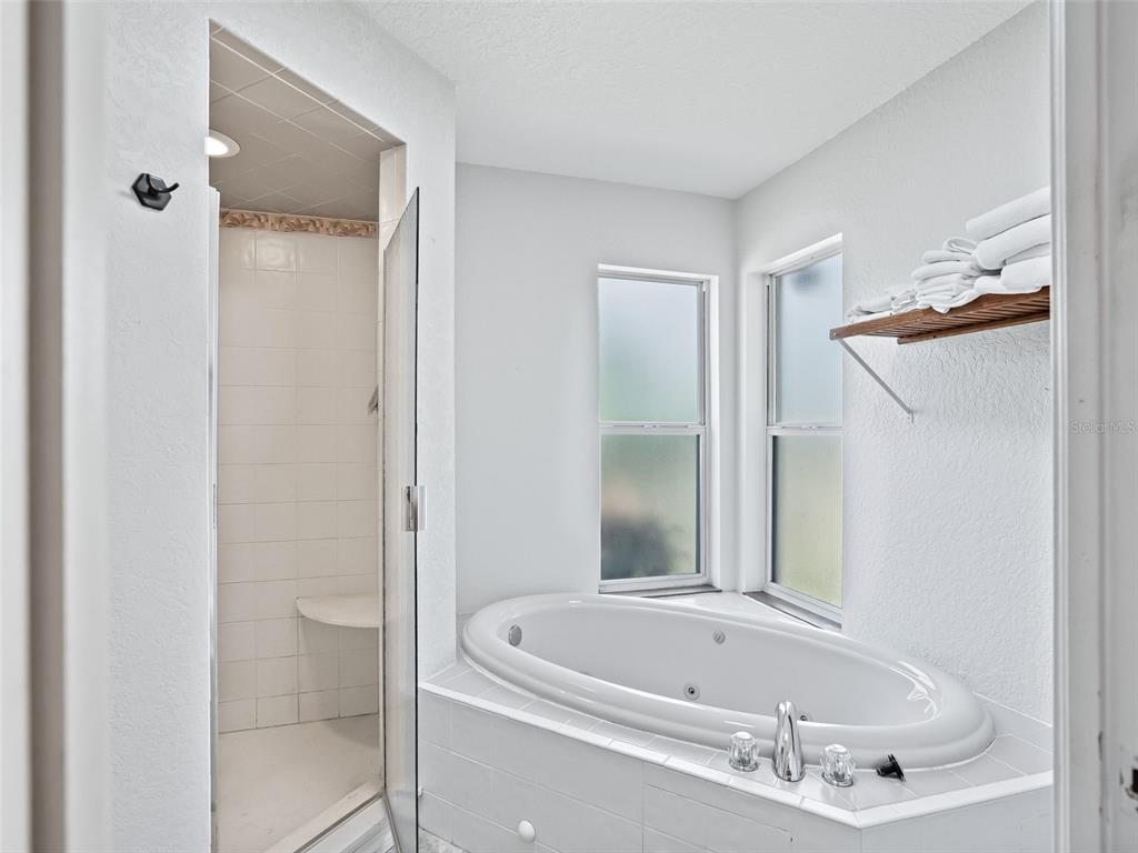 8916 Southwest 8th Street Ocala, FL 34481 - Photo 21 of 40 a bathroom with a tub and shower
