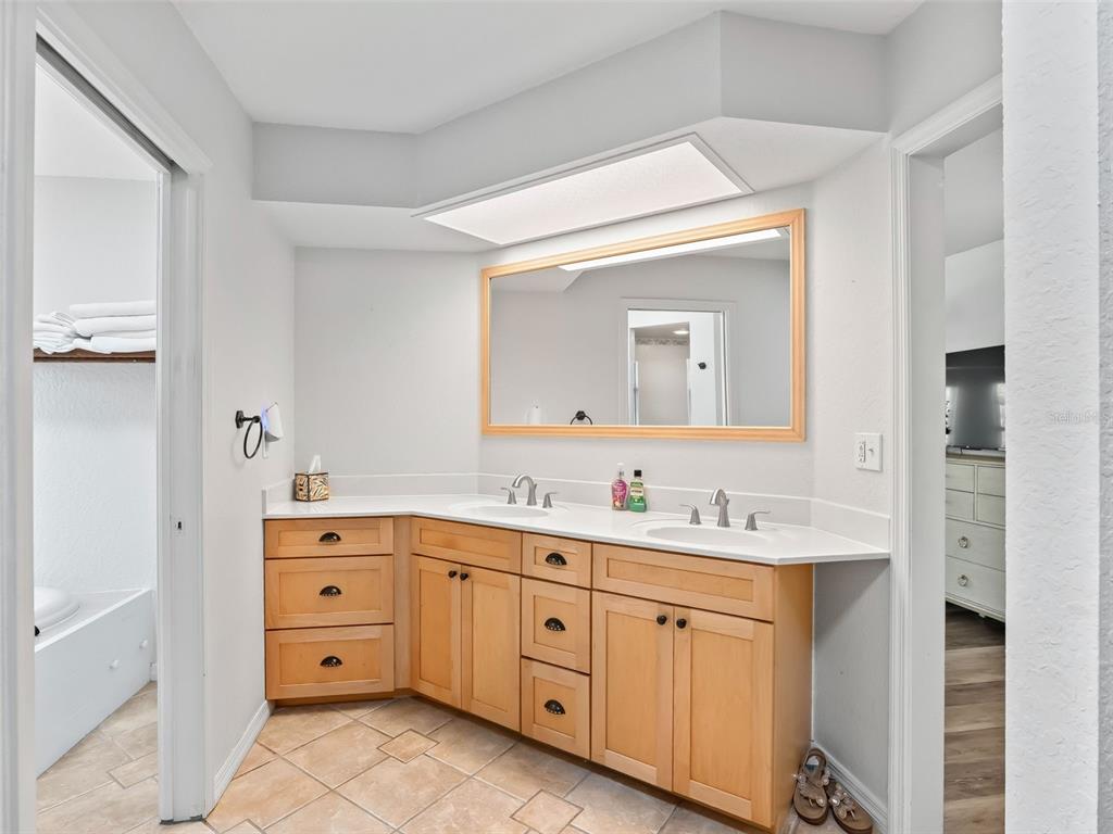 8916 Southwest 8th Street Ocala, FL 34481 - Photo 22 of 40 a spacious bathroom with a double vanity sink and mirror