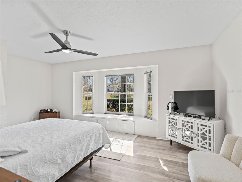 8916 Southwest 8th Street Ocala, FL 34481 - Photo 25 of 40 a bedroom with a bed and a flat screen tv