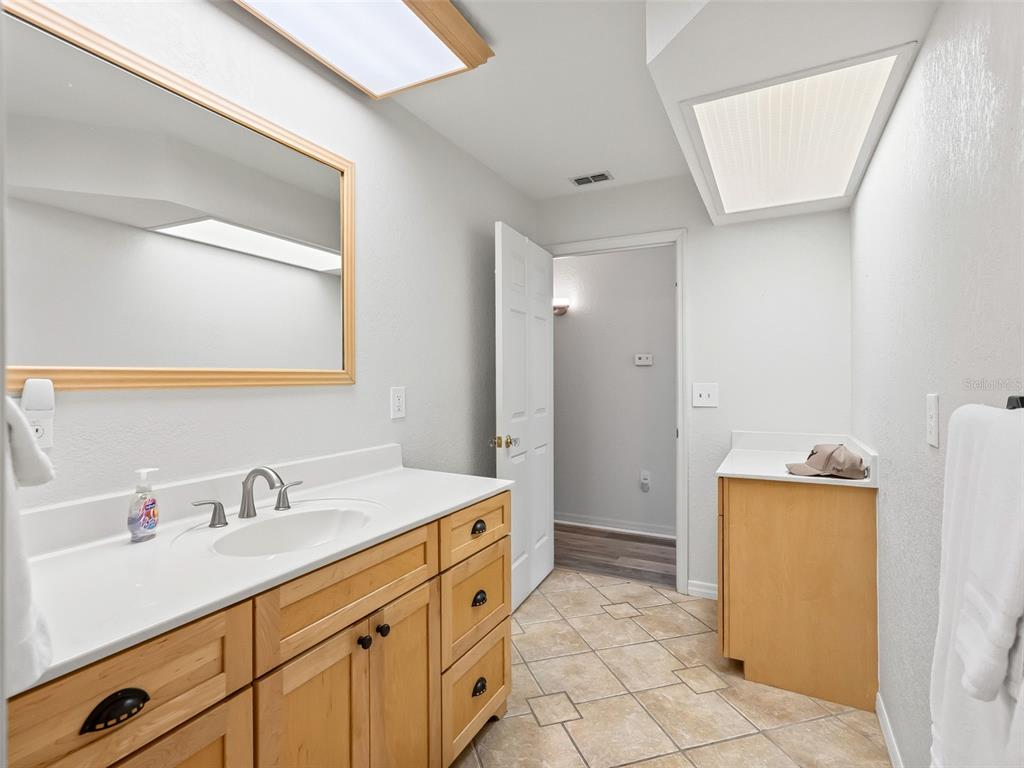 8916 Southwest 8th Street Ocala, FL 34481 - Photo 26 of 40 a spacious bathroom with a sink a mirror and a shower