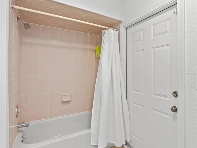 a bathroom with a shower and a bath tub