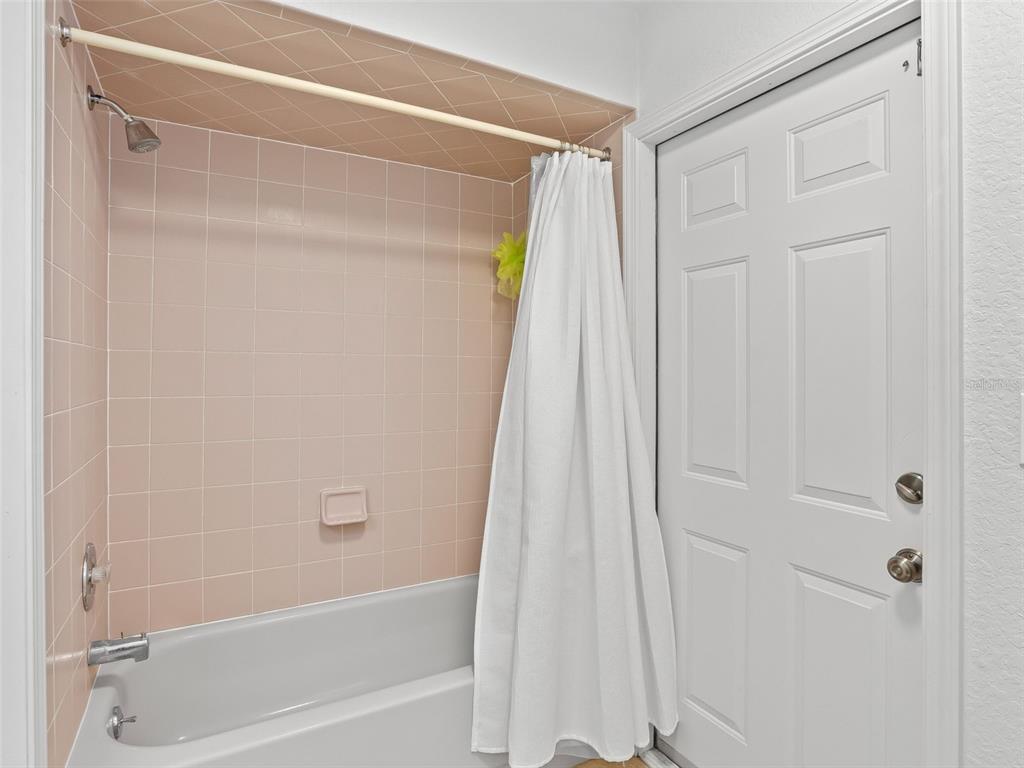 8916 Southwest 8th Street Ocala, FL 34481 - Photo 28 of 40 a bathroom with a shower and a bath tub