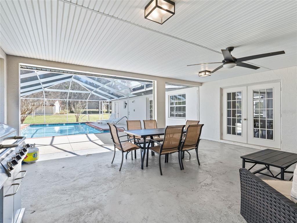 8916 Southwest 8th Street Ocala, FL 34481 - Photo 32 of 40 a dining room with furniture and a floor to ceiling window