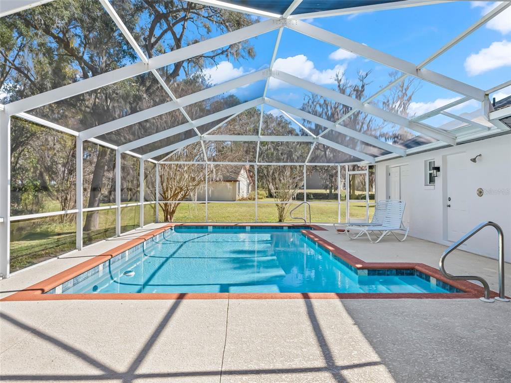 8916 Southwest 8th Street Ocala, FL 34481 - Photo 36 of 40 a view of a swimming pool with a lounge chairs