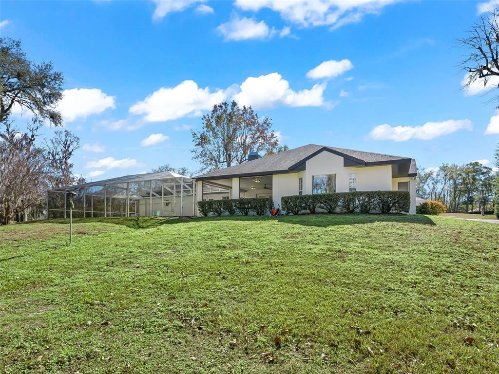 8916 Southwest 8th Street Ocala, FL 34481 - Photo 38 of 40 a front view of house with yard and trees