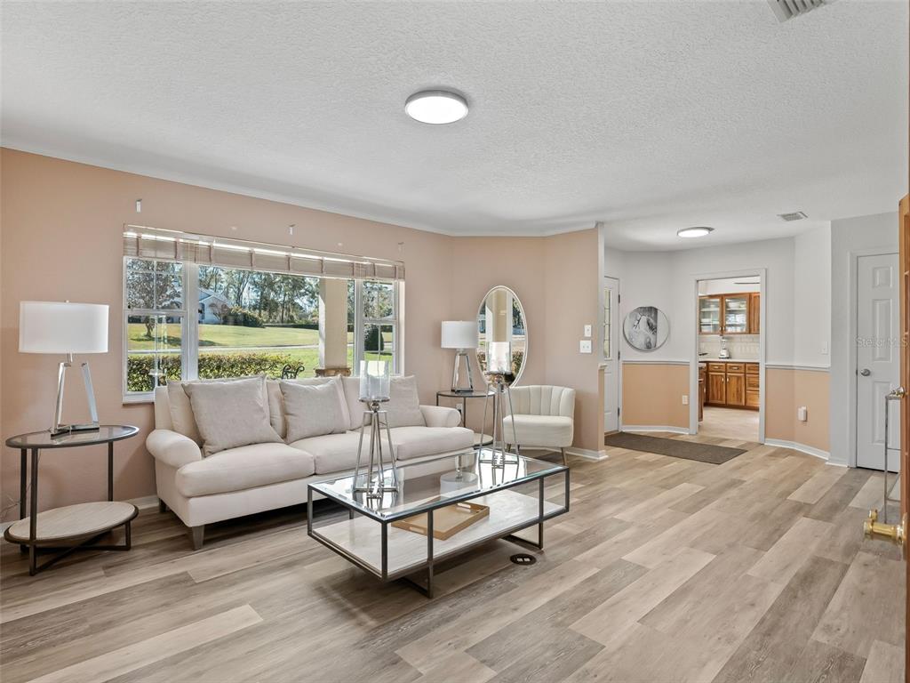 8916 Southwest 8th Street Ocala, FL 34481 - Photo 7 of 40 a living room with furniture and a large window