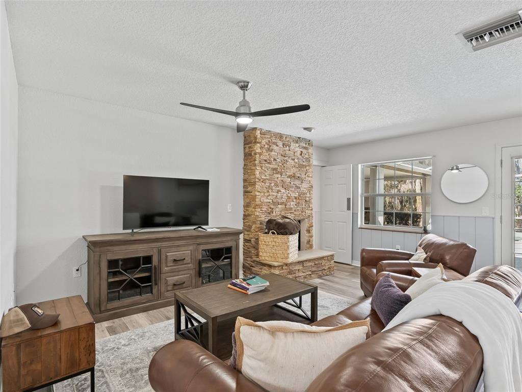 8916 Southwest 8th Street Ocala, FL 34481 - Photo 9 of 40 a living room with furniture and a flat screen tv