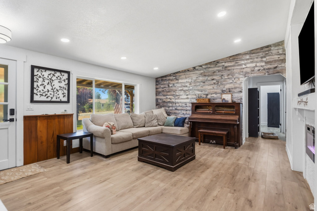 4270 River Road Oakley, UT 84055 - Photo 6 of 46 Spacious living area featuring wood-finish flooring, a textured accent wall, and recessed lighting