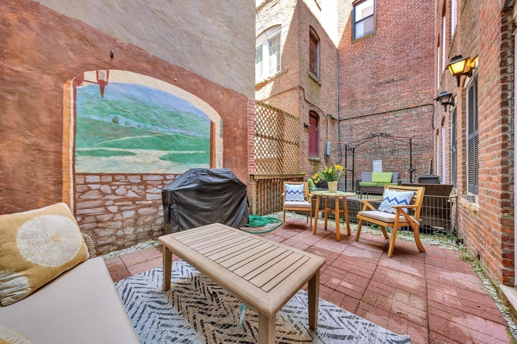 34 Clark Street, Unit 2 Boston, MA 02113 - Photo 18 of 23 a view of a patio with a dining table and chairs