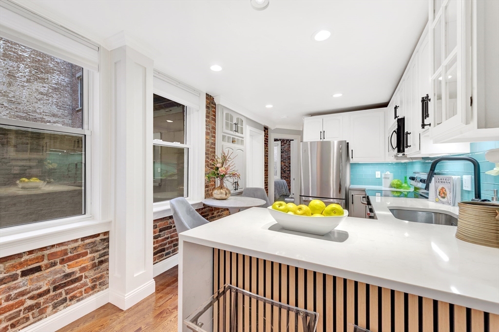 34 Clark Street, Unit 2 Boston, MA 02113 - Photo 5 of 23 a bedroom with a bed and large windows