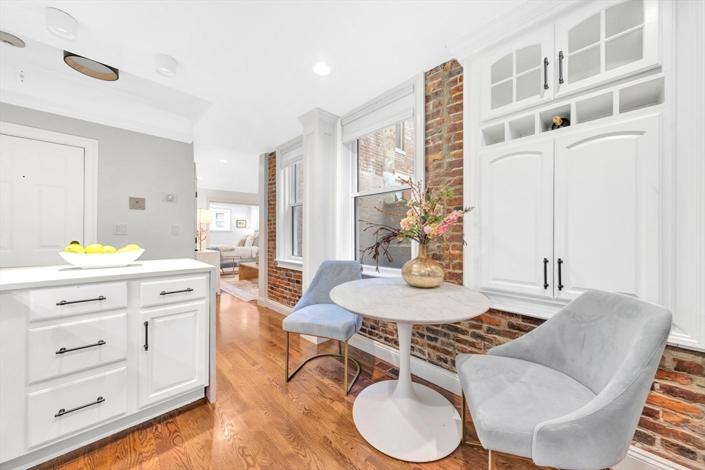 34 Clark Street, Unit 2 Boston, MA 02113 - Photo 9 of 23 a kitchen with a table chairs stove and wooden floor