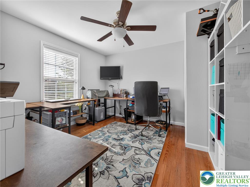 4148 Ross Road Bethlehem, PA 18020 - Photo 59 of 67 Hardwood flooring and a functional ceiling fan complete this well-lit home office, ideal for productivity.