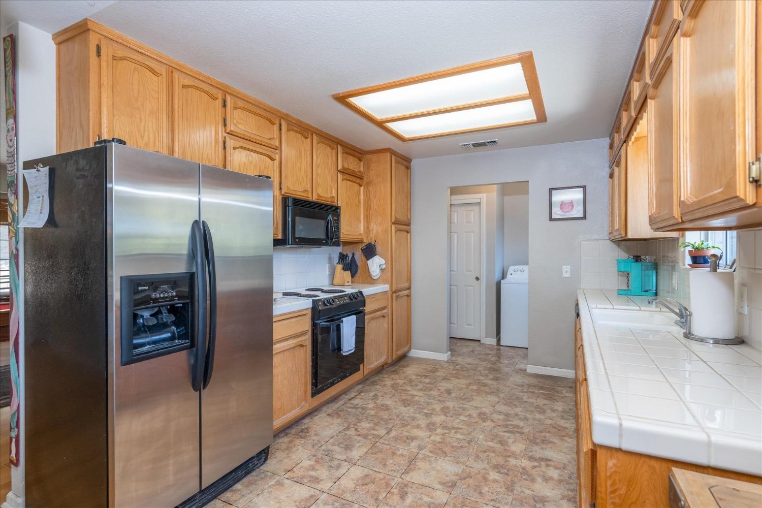 41175 Jean Road West Oakhurst, CA 93644 - Photo 17 of 43 a kitchen with stainless steel appliances granite countertop a refrigerator and a stove