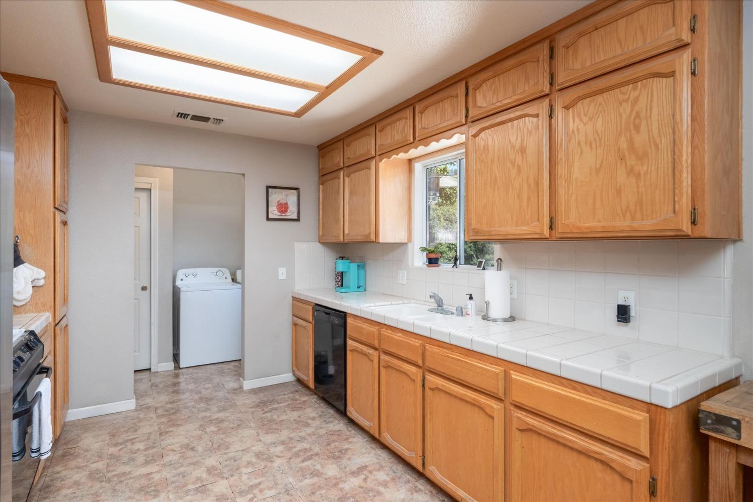 41175 Jean Road West Oakhurst, CA 93644 - Photo 18 of 43 a kitchen with stainless steel appliances granite countertop a sink stove and cabinets