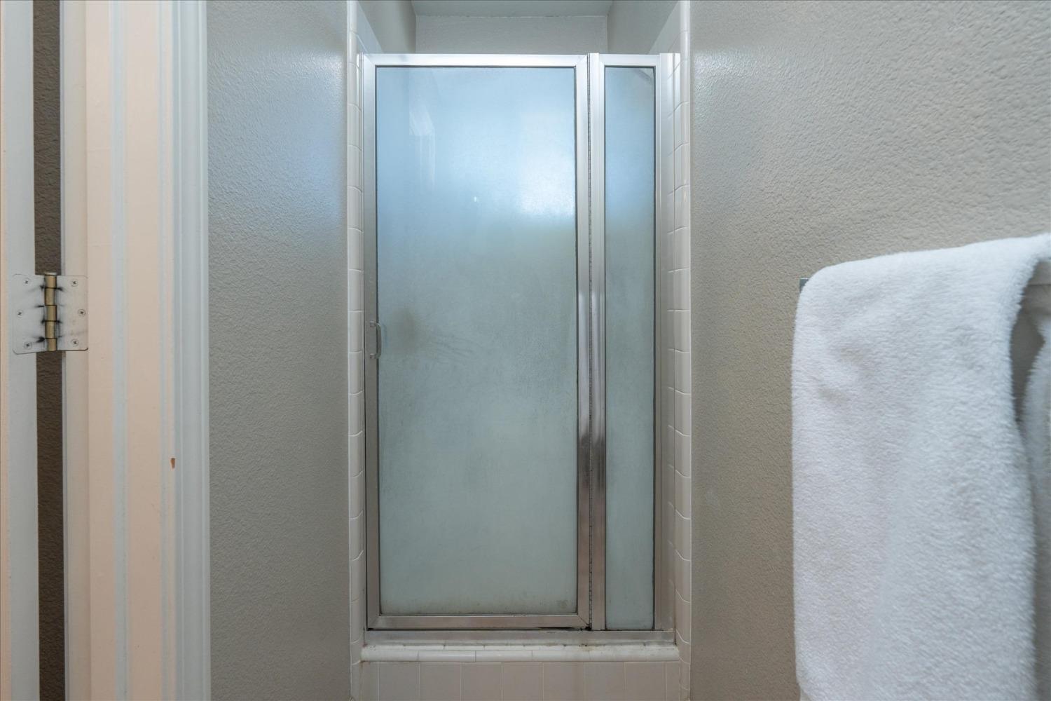 41175 Jean Road West Oakhurst, CA 93644 - Photo 23 of 43 a bathroom with a glass shower door