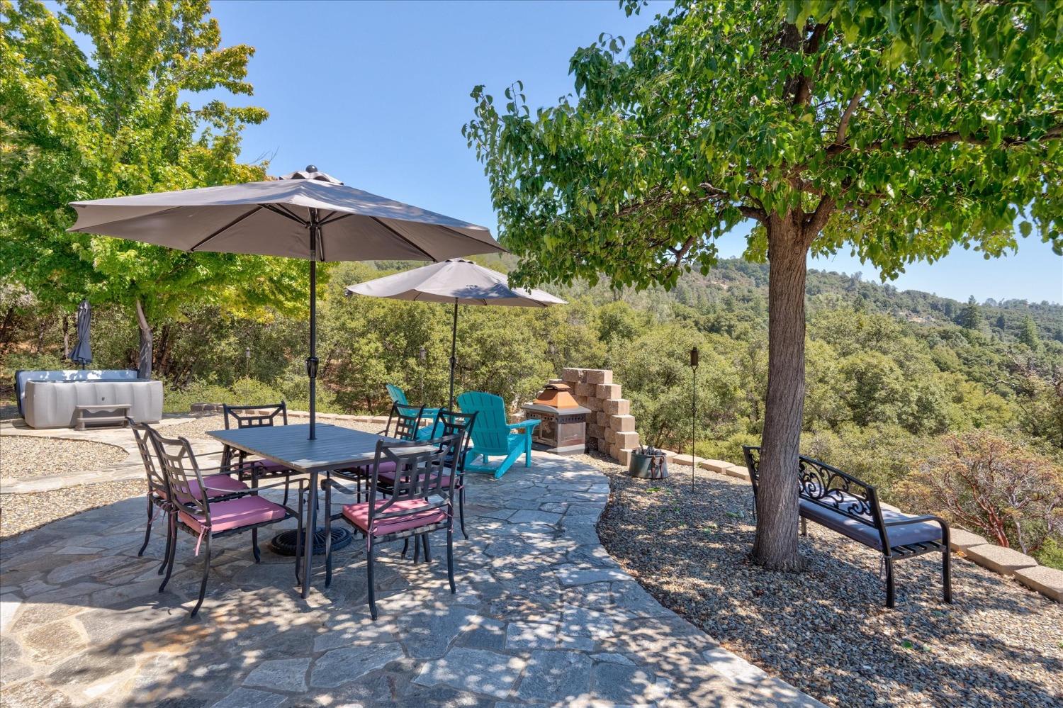 41175 Jean Road West Oakhurst, CA 93644 - Photo 31 of 43 a view of a tables and chairs under an umbrella