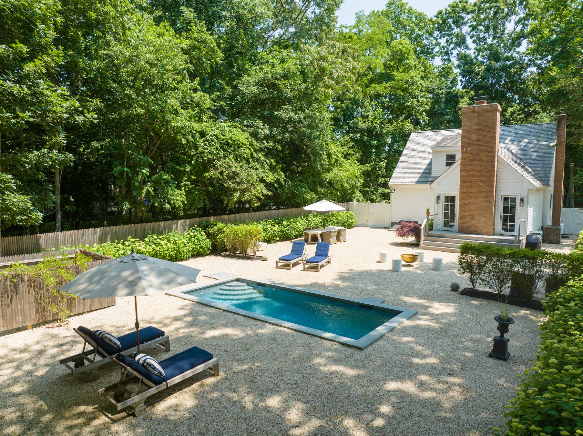 1253 Brick Kiln Road Sag Harbor, NY 11963 - Photo 11 of 31 a backyard of a house with table and chairs