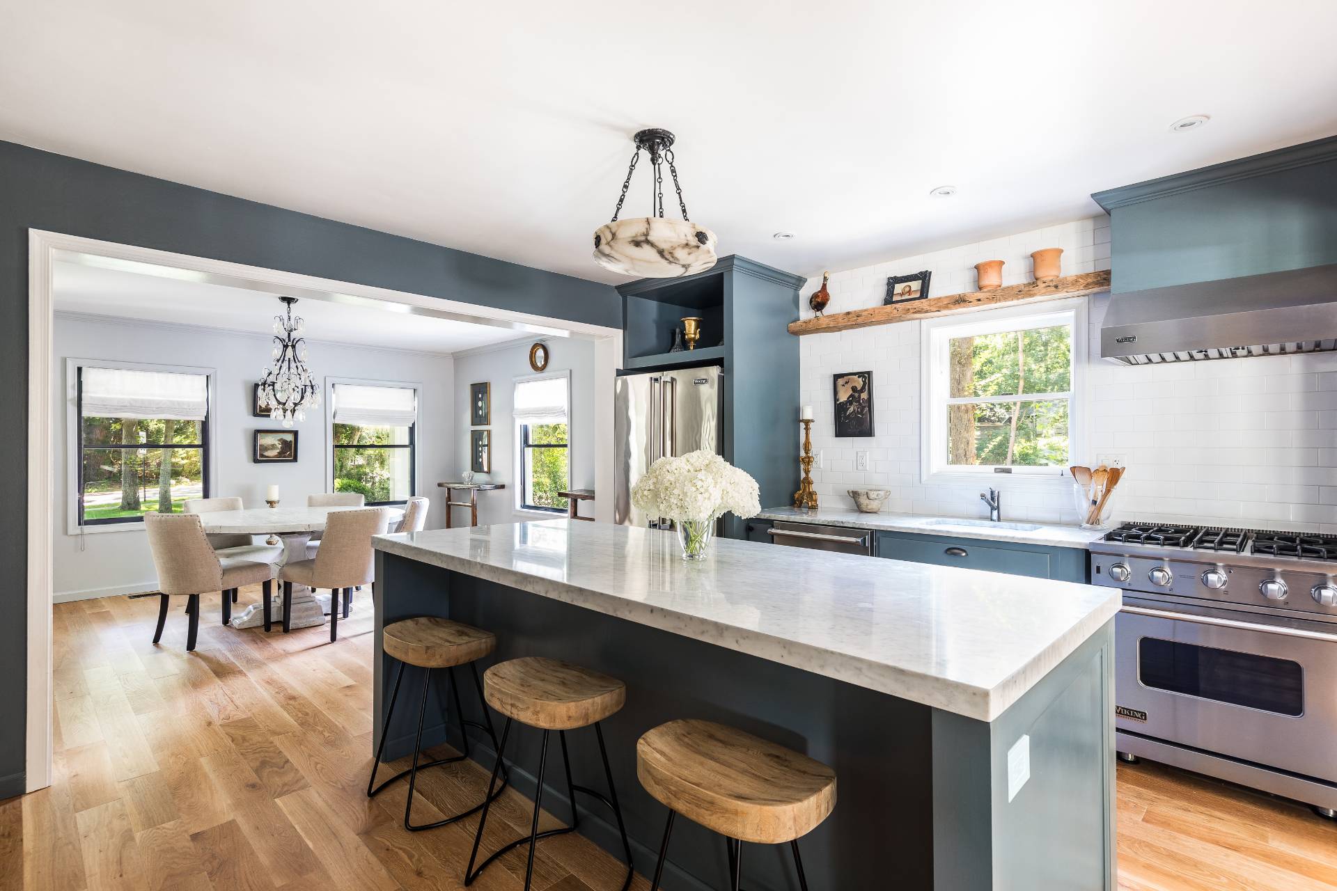 1253 Brick Kiln Road Sag Harbor, NY 11963 - Photo 19 of 31 a kitchen with a stove a sink dishwasher a dining table and chairs with wooden floor