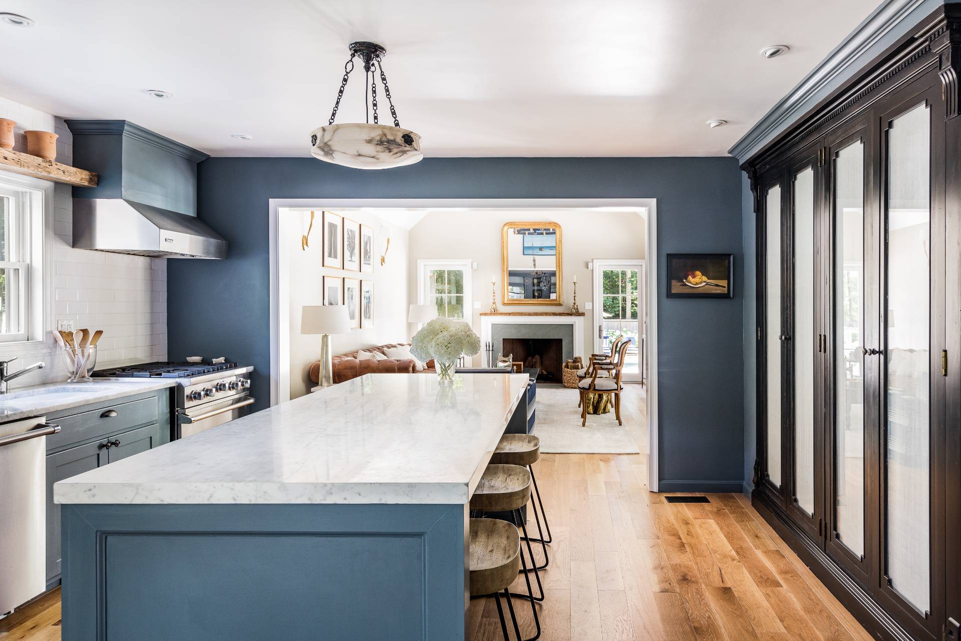 1253 Brick Kiln Road Sag Harbor, NY 11963 - Photo 20 of 31 a kitchen with stainless steel appliances granite countertop a stove refrigerator and a dining table with wooden floor