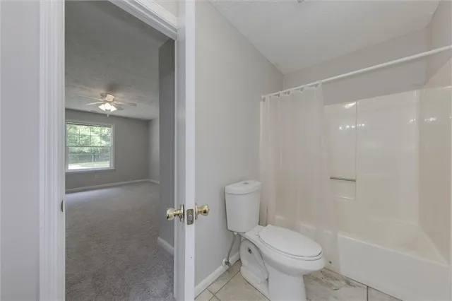 a bathroom with a toilet sink and shower