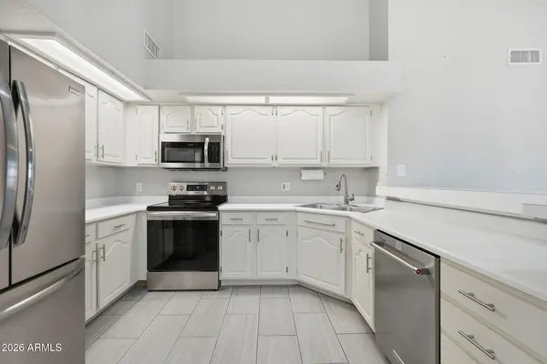 a kitchen with a sink stove and refrigerator