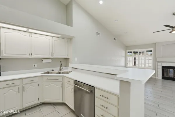a kitchen with cabinets appliances a sink and a counter top space