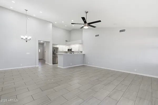 a view of a kitchen with a sink and a refrigerator