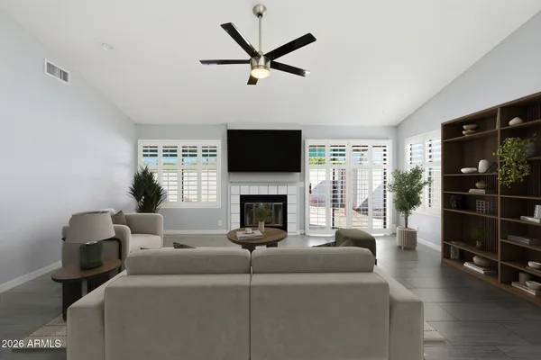 a living room with furniture a fireplace and a flat screen tv