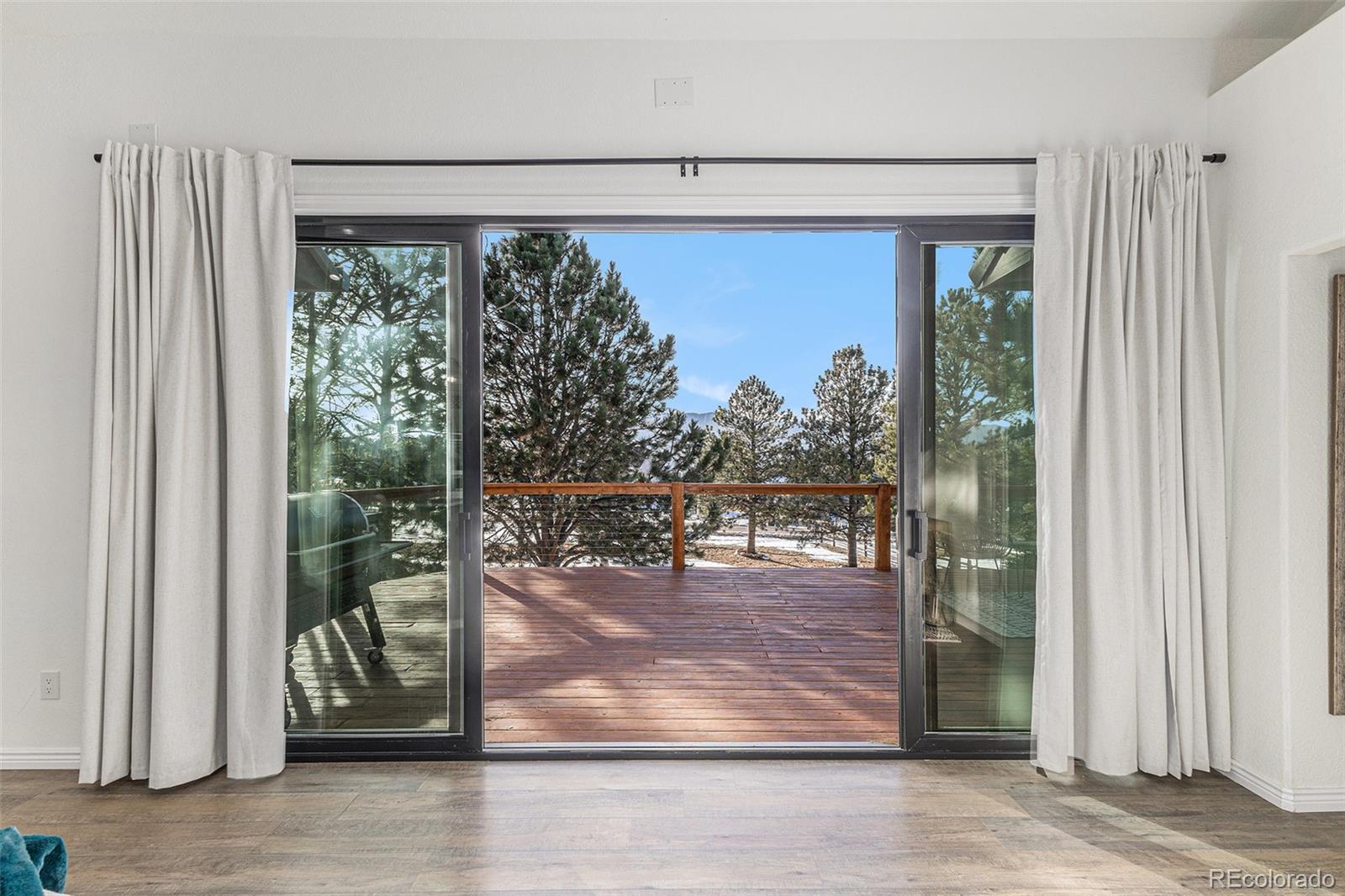 17870 New London Road Monument, CO 80132 - Photo 11 of 44 a view of a living room and floor to ceiling window