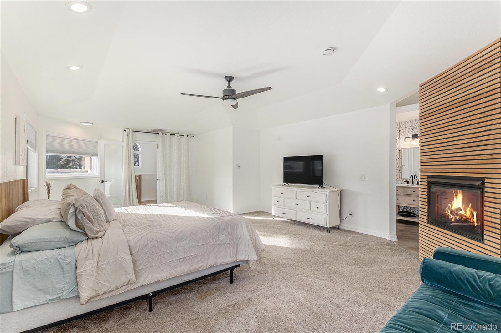 17870 New London Road Monument, CO 80132 - Photo 13 of 44 a bedroom with a bed and a flat screen tv