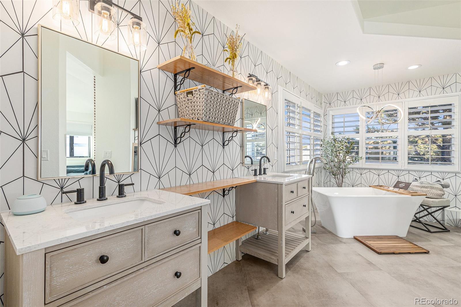 17870 New London Road Monument, CO 80132 - Photo 16 of 44 a bathroom with a double vanity sink a mirror and a bathtub