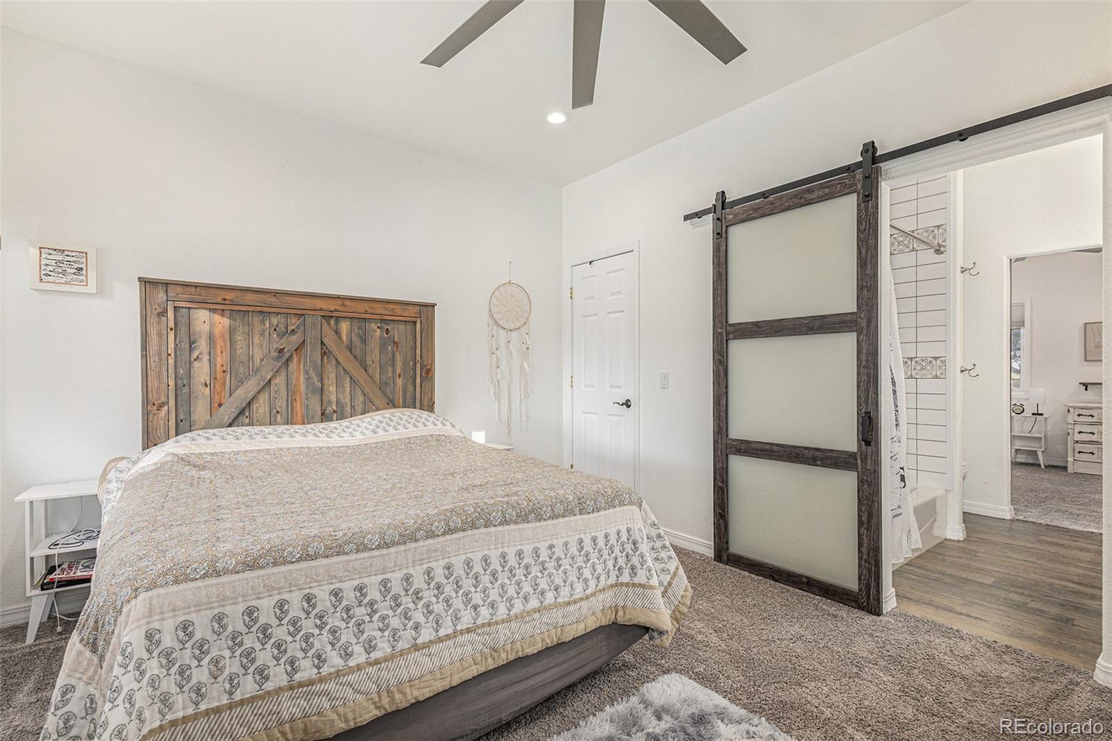 17870 New London Road Monument, CO 80132 - Photo 17 of 44 a bedroom with a bed and wooden floor
