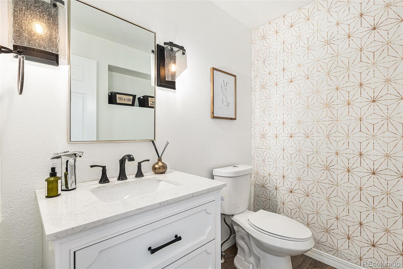 17870 New London Road Monument, CO 80132 - Photo 20 of 44 a bathroom with a sink a toilet and a mirror