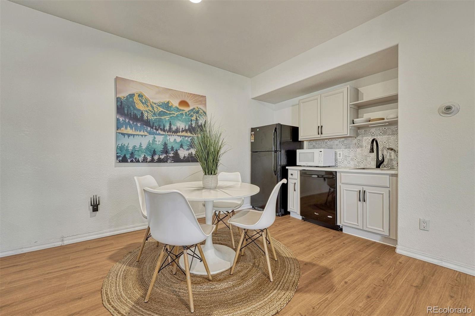 17870 New London Road Monument, CO 80132 - Photo 24 of 44 a view of a dining room with furniture and wooden floor