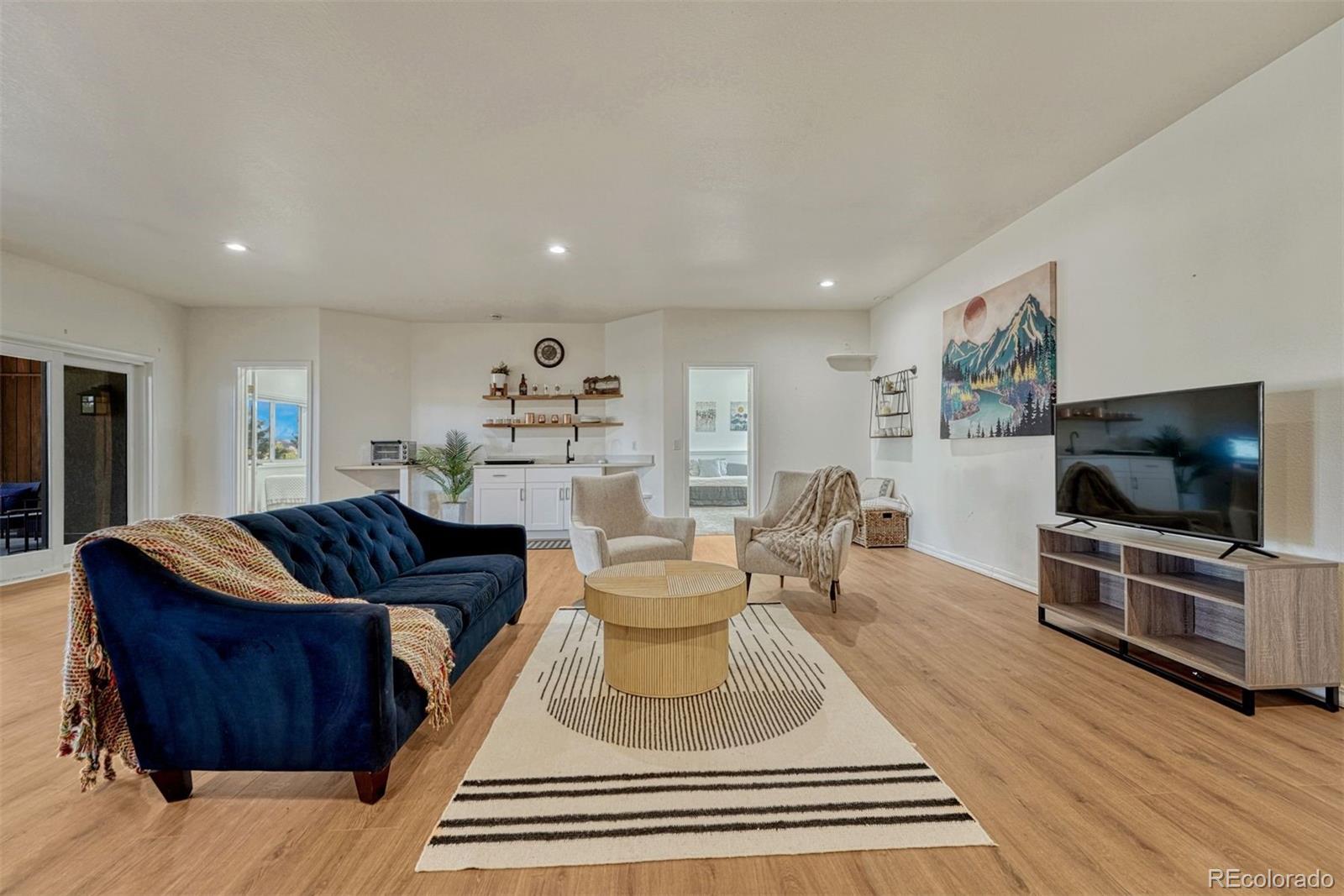 17870 New London Road Monument, CO 80132 - Photo 25 of 44 a living room with furniture and a flat screen tv