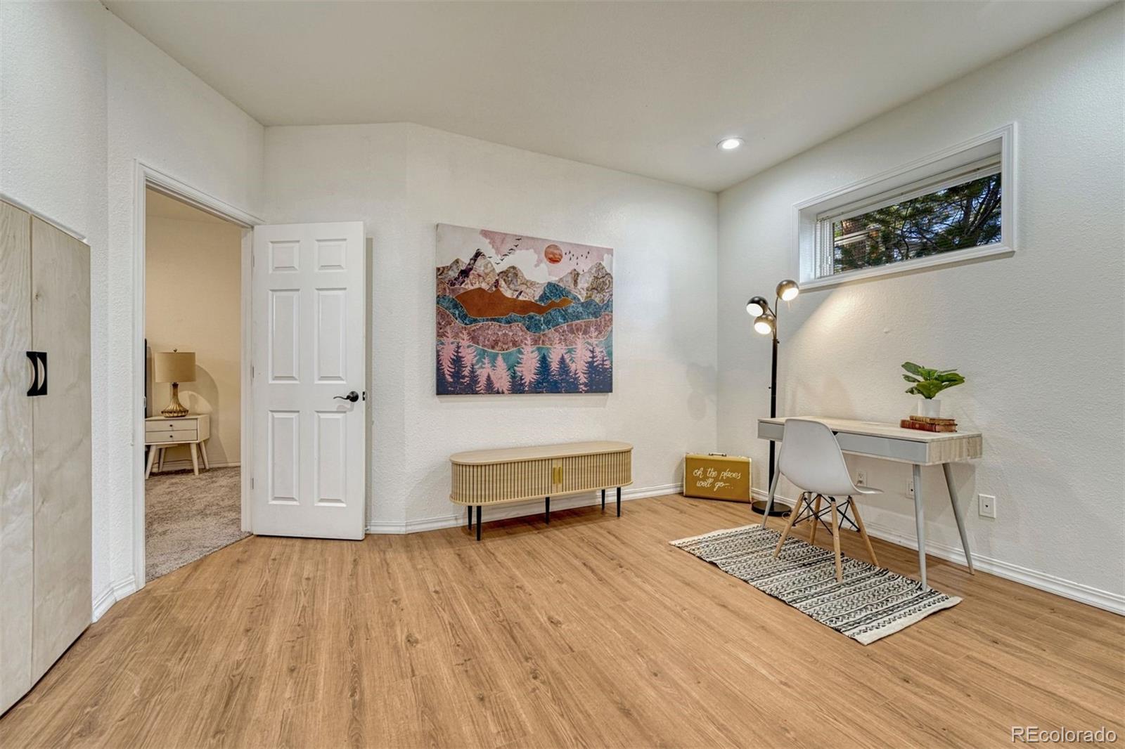 17870 New London Road Monument, CO 80132 - Photo 27 of 44 a living room with furniture and a wooden floor