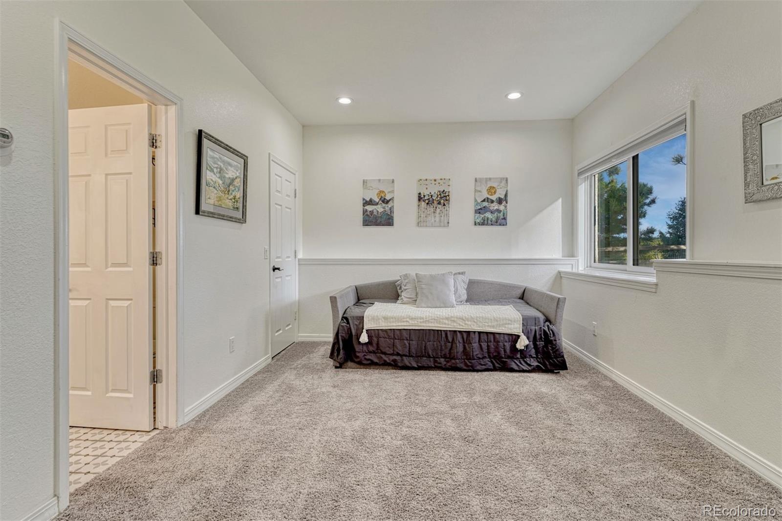 17870 New London Road Monument, CO 80132 - Photo 31 of 44 a spacious bedroom with a bed and a window