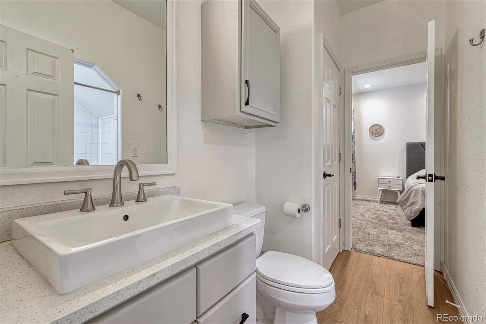 17870 New London Road Monument, CO 80132 - Photo 34 of 44 a bathroom with a sink a toilet and shower