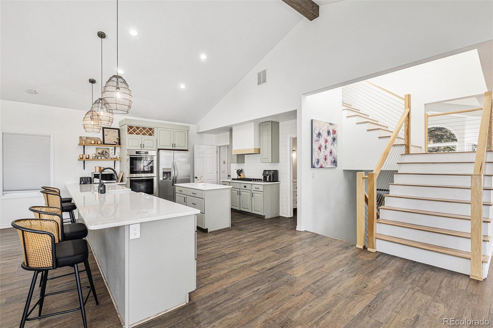 17870 New London Road Monument, CO 80132 - Photo 9 of 44 a open kitchen with white cabinets and stainless steel appliances