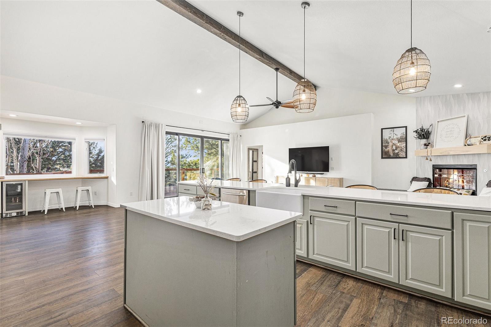 17870 New London Road Monument, CO 80132 - Photo 10 of 44 a open kitchen with a sink and dishwasher with wooden floor