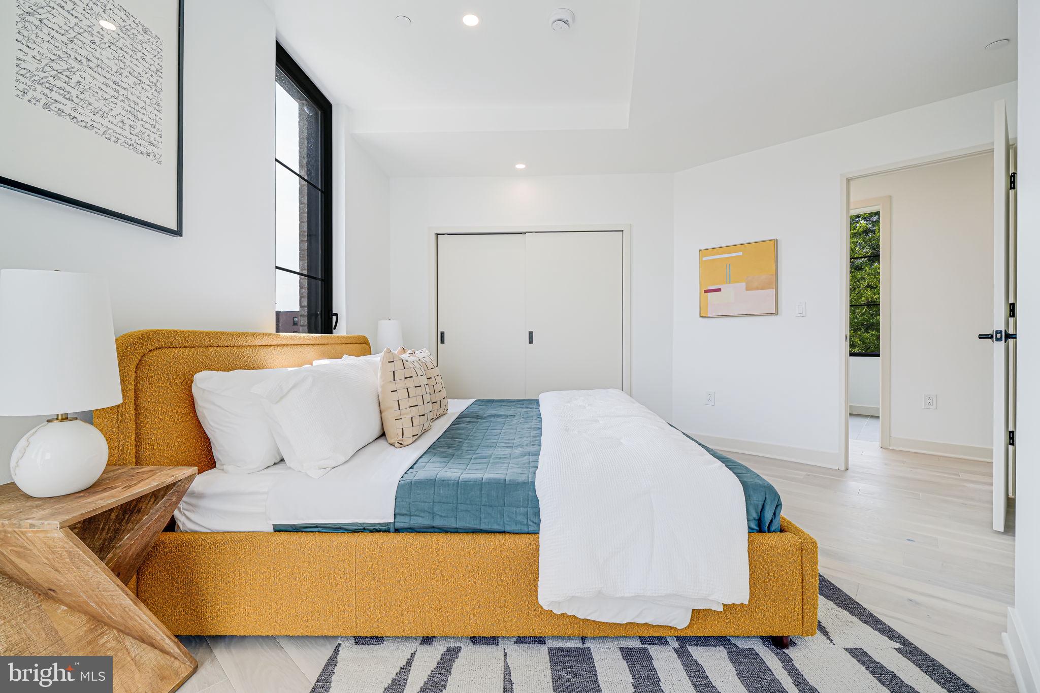 2901 Newark Street Northwest Washington, DC 20008 - Photo 11 of 52 a bedroom with a bed and painting on the wall