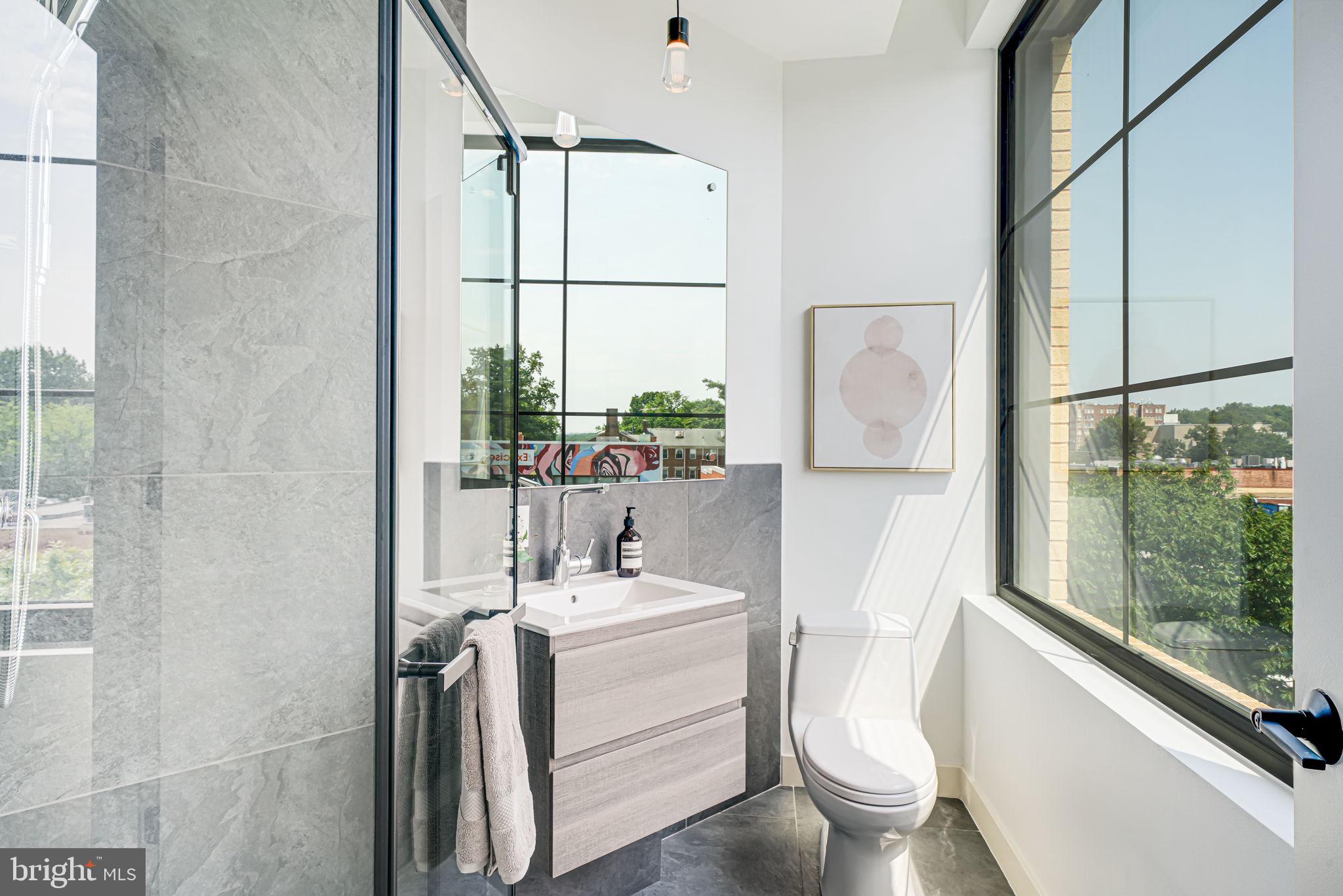 2901 Newark Street Northwest Washington, DC 20008 - Photo 13 of 52 a bathroom with a sink toilet and shower