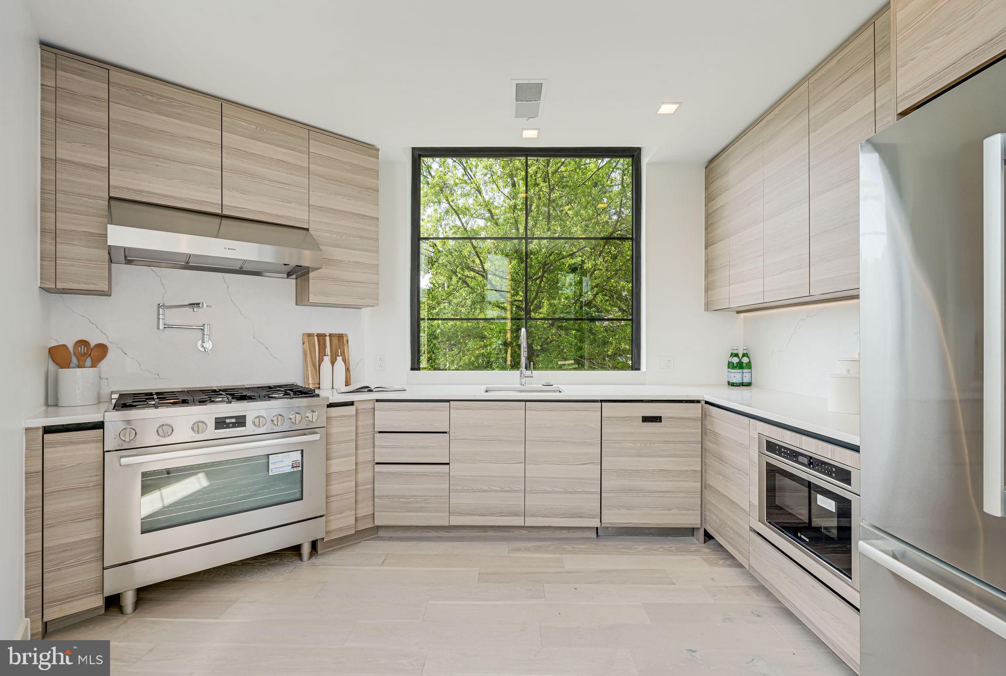 2901 Newark Street Northwest Washington, DC 20008 - Photo 4 of 52 a kitchen with white cabinets and white appliances
