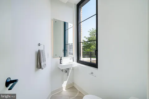 a bathroom with a toilet sink and mirror