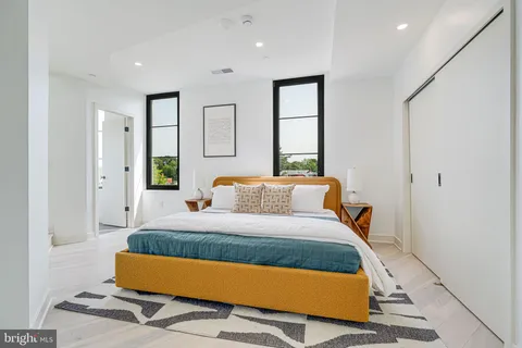 a bedroom with a bed and window